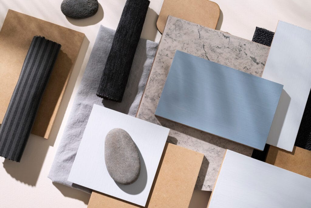 Moodboard de materiais sustentaveis para arquitetura com amostras de madeira, pedras naturais, tecidos e ceramica.